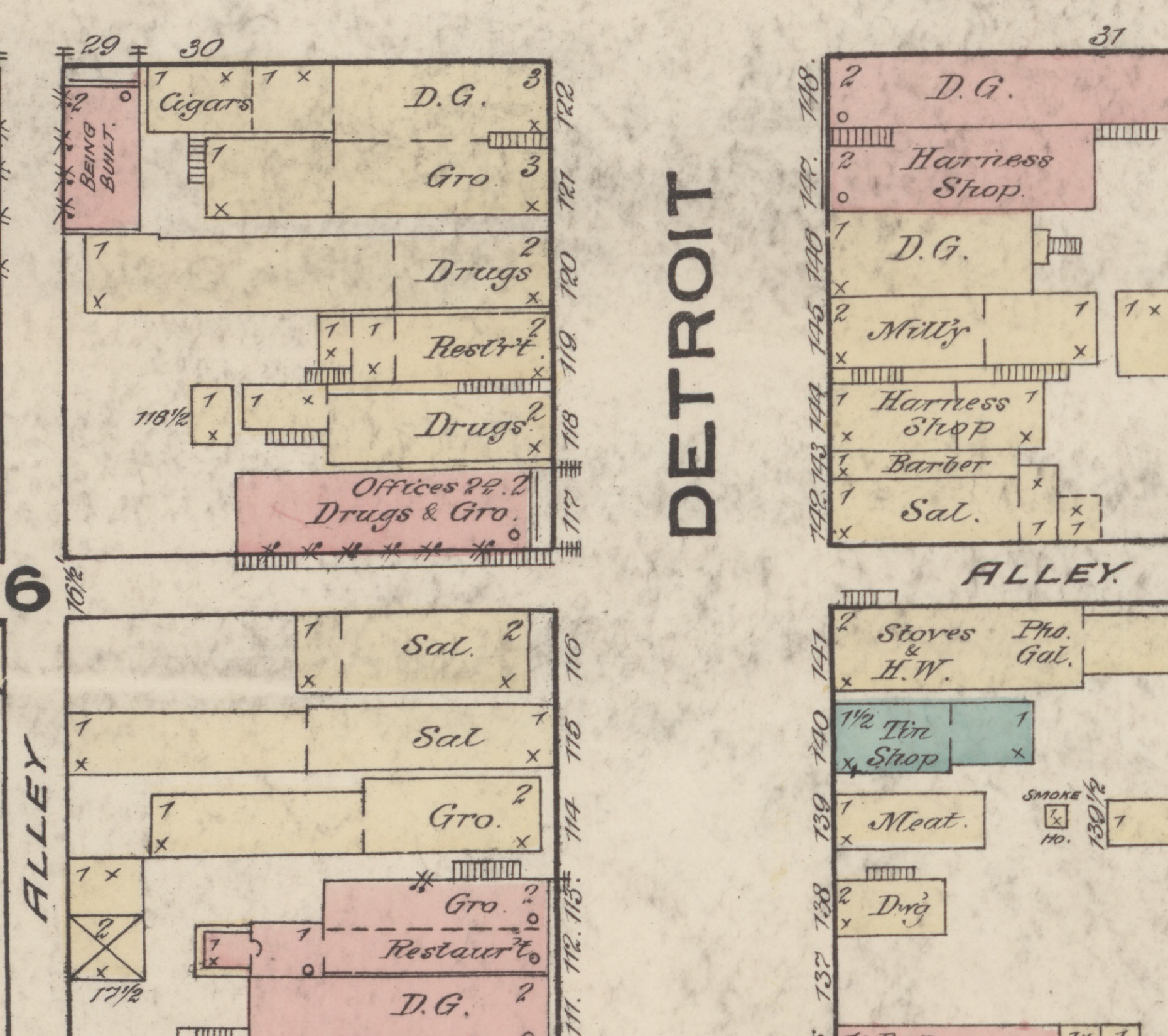 A detail from an 1883 fire insurance map showing both faces of Detroit Street in LaGrange, the street name lettered vertically down the middle. Buildings are drawn as coloured blocks with their trade written inside and the street number outside. On the west side, reading down, Cigars, dry goods, groceries, Drugs, a restaurant, and offices over Drugs and groceries; then, below a break, two adjoining buildings lettered Sal. at 116 and Sal at 115, a grocery at 114, and a bank at the foot. On the east side, dry goods, two harness shops, a millinery, a barber at 143, and a third building lettered Sal. at 142, with an alley below it. Storey counts and small crosses mark each building.