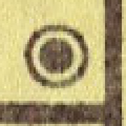 A post office symbol from the map, greatly enlarged: a dark dot inside a ring, with a light band between them.