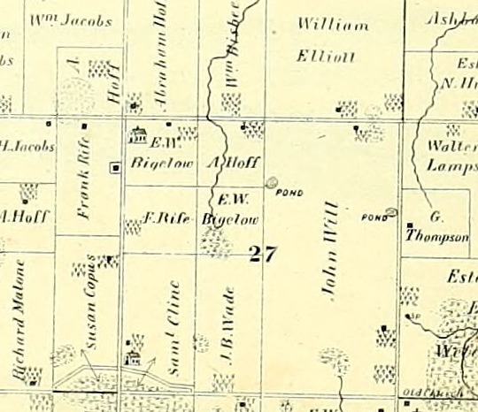 A detail from an 1874 county atlas plate. Two roads cross at the upper left. Just below the east to west road and just east of the north to south one, a small building is drawn in elevation rather than in plan, gabled, with a belfry on its ridge and a fence along its front. No name is printed beside it. The name E. W. Bigelow is lettered immediately to its right, A. Hoff beyond that, and Frank Rife in the field to the west. The section below is numbered 27.